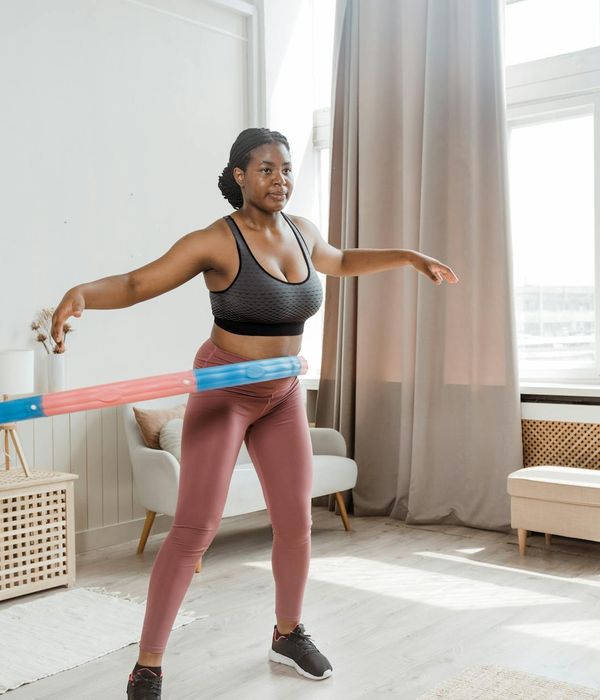 Woman feeling energetic and balanced in a bright room.